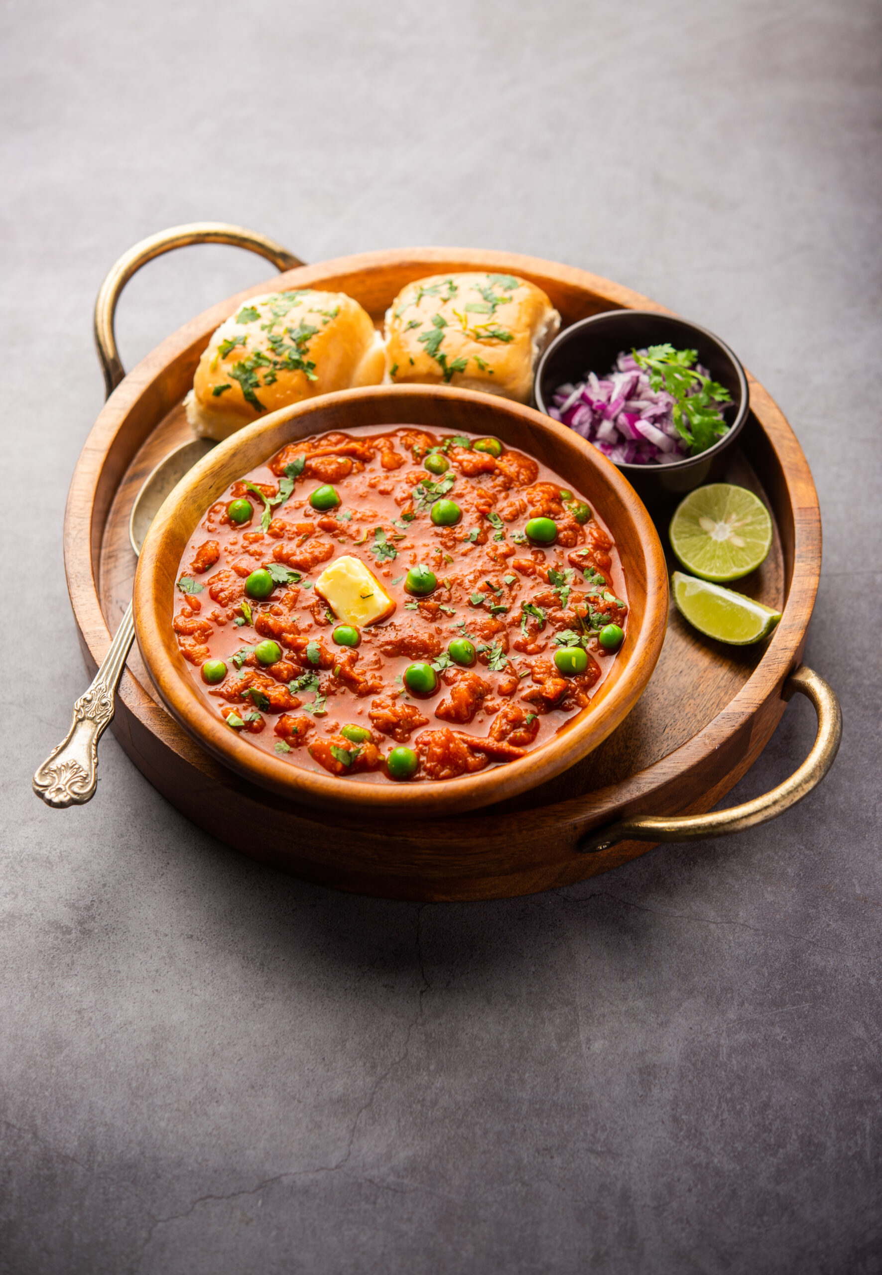 Pav bhaji is a fast food dish from India consisting of a thick vegetable curry served with a soft bread roll